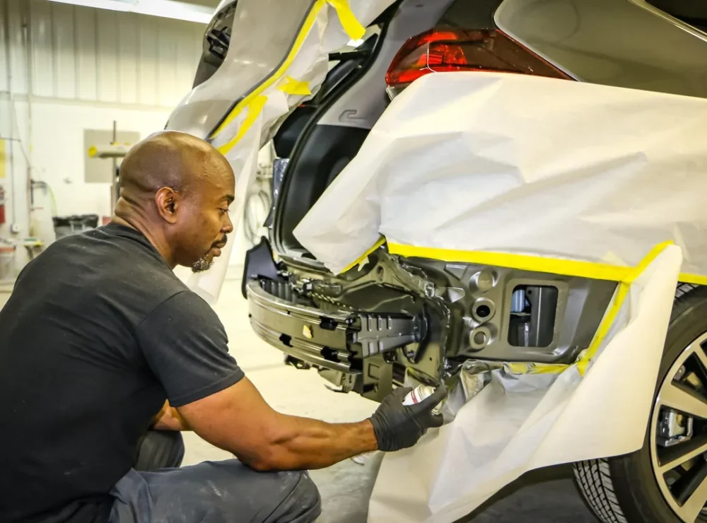 Technician repairing the rear bumper of a car